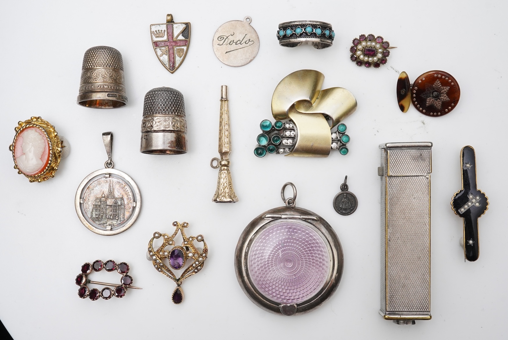 A small group of assorted collectables and jewellery including a Dunhill lighter, 64mm, a George V silver and enamel small compact, silver thimble, two Victorian garnet set brooches, an Edwardian 9ct, amethyst and seed p